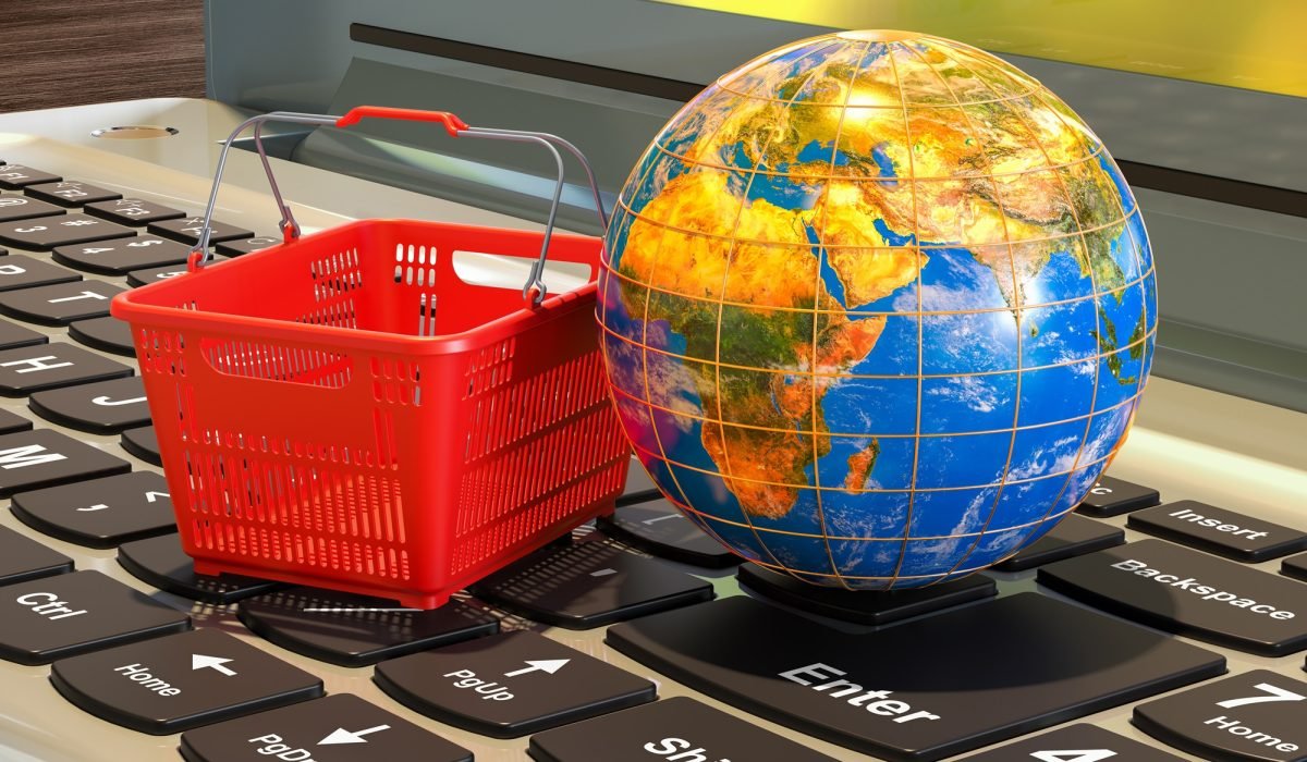 Global Online shopping concept, laptop keyboard with shopping basket. 3D rendering