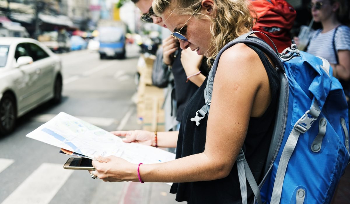 Caucasian woman browsing around using Bangkok Thailand map