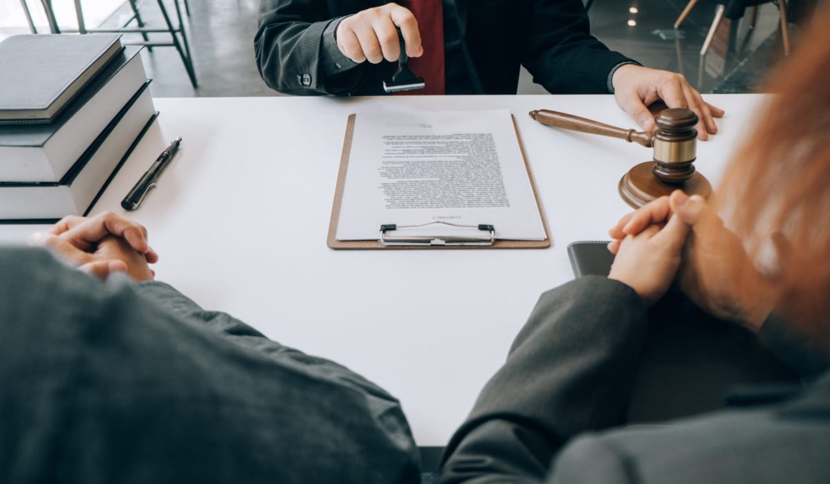 smart lawyer holding stamp for submit documents  with advice in the office before considering the judgment, lawyer concept